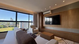 Sala de estar com sofá e grande janela com vista para a paisagem.