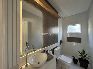 Foto de um banheiro moderno com pia e vaso sanitário.