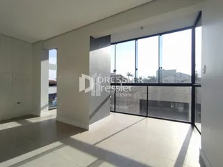 Ambiente interno com grandes janelas que iluminam o espaço.
