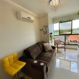 Sala de estar com sofá e iluminação clara em um imóvel.