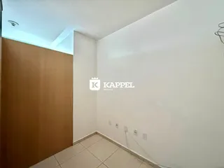 Foto de um ambiente interno com piso de cerâmica clara e paredes brancas.