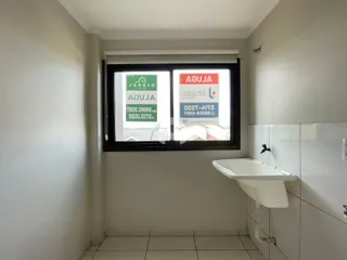 Vista interna de um ambiente com pia e janela.