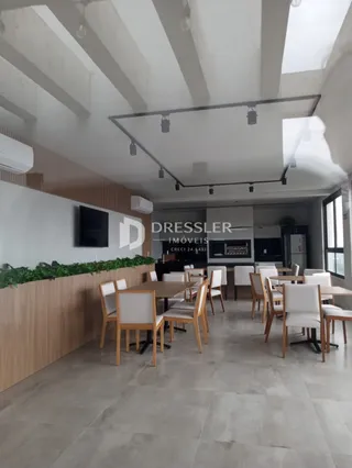 Ambiente interno com mesa de jantar e painel de madeira.