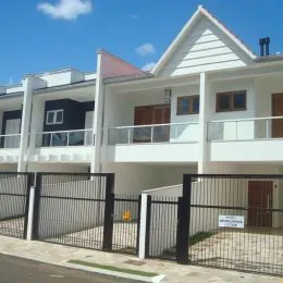 Fachada de uma residência branca com telhado inclinado em Lajeado, Brasil.