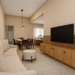 Sala de estar com sofá branco e televisão na parede.