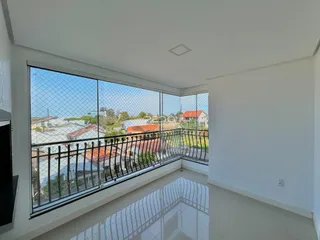 Vista da sala com grande janela para o entorno residencial.
