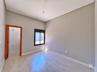 Sala de estar com paredes cinzas e piso claro.