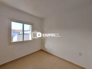 Foto de um cômodo interno com paredes brancas e piso claro.