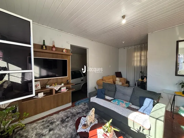 Sala de estar com sofá e televisão em um apartamento no Brasil.