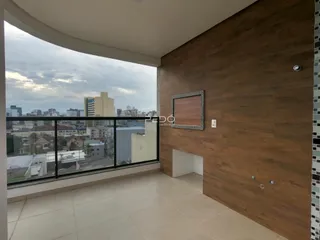 Sala de estar com vista para a paisagem urbana através da varanda.