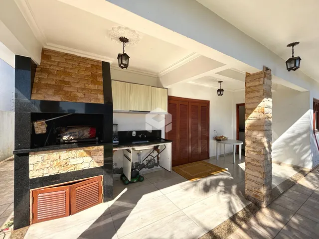 Interior de uma sala de estar com lareira de pedra e piso de cerâmica.