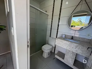 Foto de um banheiro interno com revestimento de azulejos brancos.