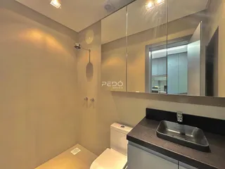 Foto de um banheiro moderno com bancada e espelho.