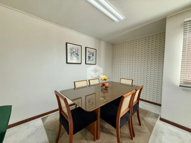 Foto de uma sala de jantar com mesa de madeira em um imóvel no Brasil.