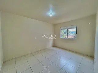 Ambiente interno de uma sala com piso de cerâmica branca.