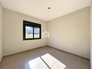 Ambiente interno de uma sala vazia com piso de concreto.