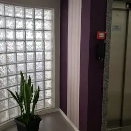 Foto de uma janela com venezianas brancas em um imóvel.