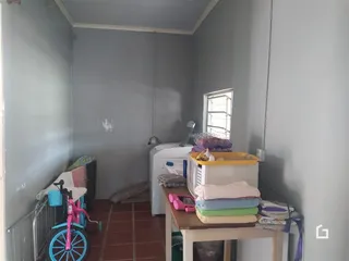 Imagem de um cômodo interno com paredes claras e piso de cerâmica.