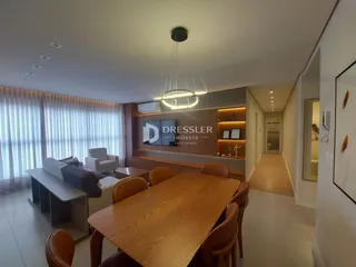 Interior de uma sala de jantar com mesa de madeira e estantes na Lajeado.