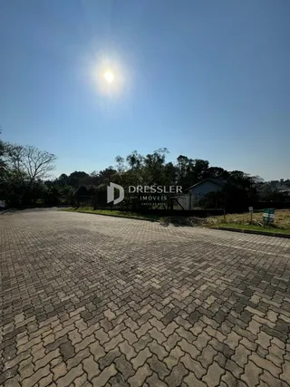 A foto mostra uma área pavimentada de frente para uma propriedade.