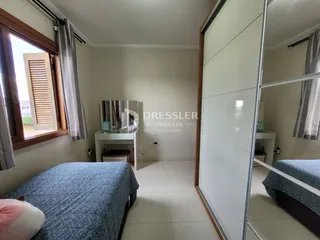 Quarto com janela e porta de vidro espelhada em imóvel no Brasil.