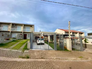 Fachada de uma residência em Lajeado, Brasil, com portão de ferro e área externa.