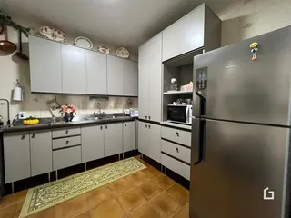 Foto de uma cozinha com armários cinzas e piso de cerâmica.