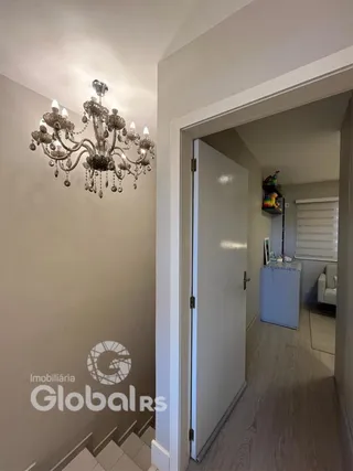 Hall com escadaria e porta em imóvel.