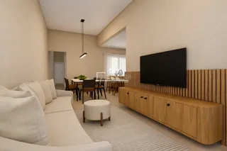 Sala de estar com sofá e área de jantar em um imóvel.