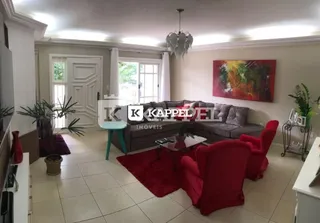Sala de estar com sofá e pintura na parede.