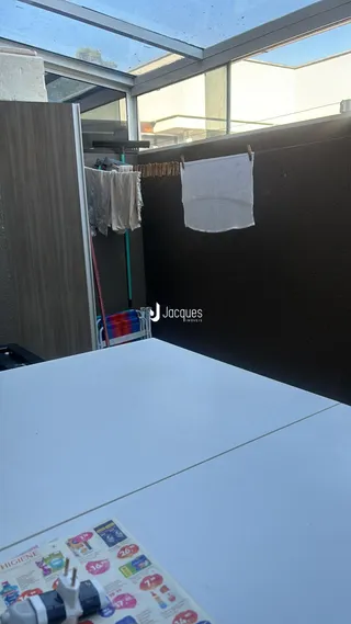 Vista interna de um imóvel com grandes janelas e paredes escuras.