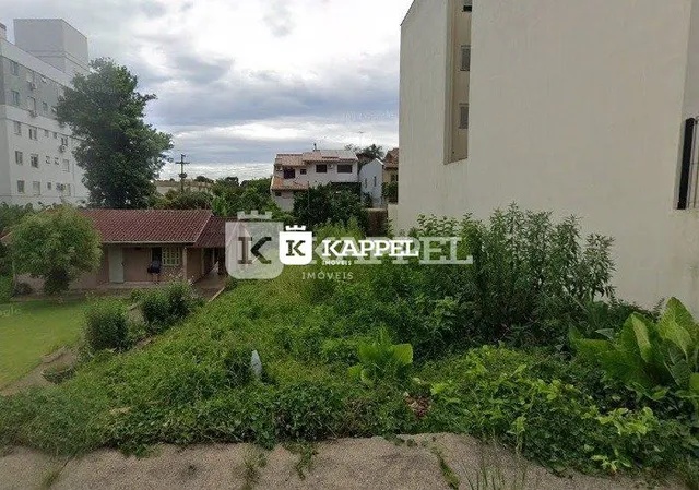 Foto da fachada de uma residência em Lajeado, Brasil, com vegetação no primeiro plano.