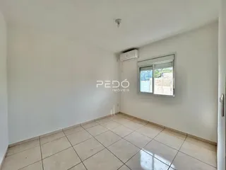 Vista interna de um cômodo com piso de cerâmica clara e paredes brancas.