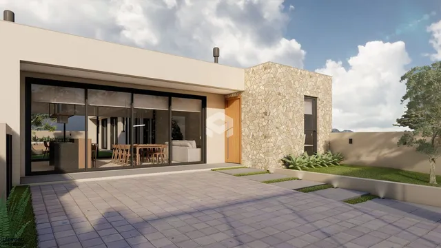 Fachada de uma residência moderna com revestimento de pedra e área externa pavimentada.