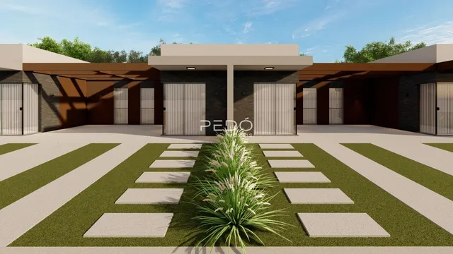 Fachada de uma residência moderna com revestimento de tijolo e portas de vidro.