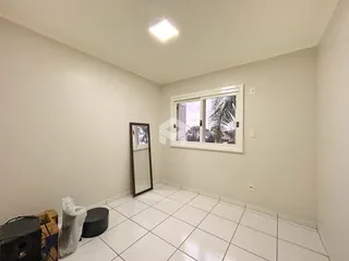 Uma sala com piso de cerâmica e janela em um imóvel.
