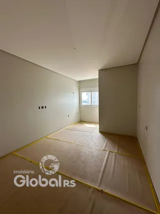 Vista interna de um corredor com paredes brancas e piso claro.