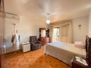 Quarto com piso de madeira e armário de madeira em Lajeado.