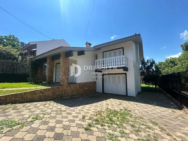 Fachada de uma casa em Lajeado, Brasil, com muro e área pavimentada na frente.