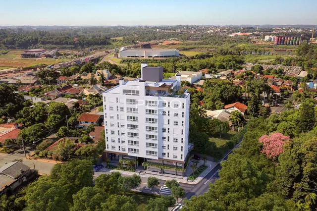 Vista aérea de um edifício residencial em Lajeado, Brasil, cercado por vegetação densa.