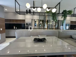 Ambiente moderno de sala de estar e cozinha em um imóvel no Brasil.