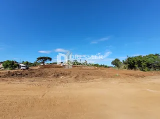 Terreno de terra seca sob um céu azul.