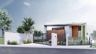 Fachada moderna de uma residência em Lajeado, Brasil, com muro e portão de vidro.