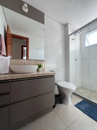 Foto de um banheiro moderno com bancada e box de vidro.