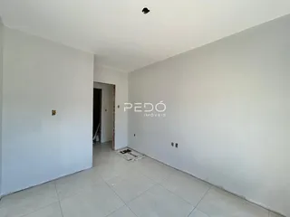 Hall de entrada com paredes brancas e piso de cerâmica.