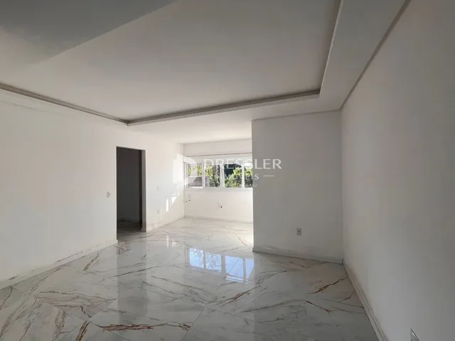 Ambiente interno amplo com piso de mármore polido.