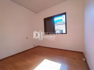 Interior de um cômodo com piso de madeira clara.
