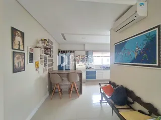 Ambiente interno claro com parede branca e decoração na sala.