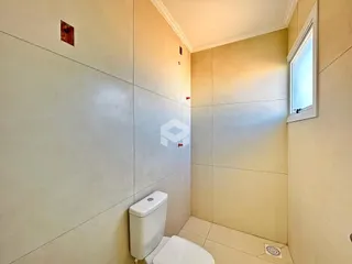 Foto de um banheiro com paredes brancas e piso claro.