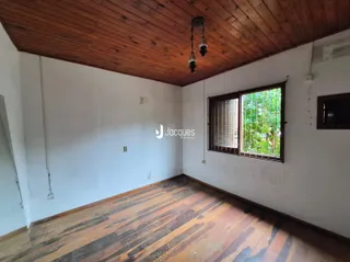Ambiente interno com piso de madeira e teto de madeira em uma residência.